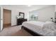 Bedroom featuring a large window and a dark wood dresser at 3512 Gibbon Terrace Ct, Charlotte, NC 28269
