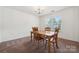 Cozy dining room featuring carpet, a wooden table with four chairs, and a window at 3512 Gibbon Terrace Ct, Charlotte, NC 28269