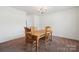 Inviting dining room with carpet, a wooden table with four chairs, and neutral walls at 3512 Gibbon Terrace Ct, Charlotte, NC 28269