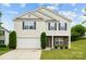 Charming two-story home featuring a two-car garage, landscaped yard, and stone accents, perfect for suburban living at 3512 Gibbon Terrace Ct, Charlotte, NC 28269