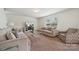 Cozy living room featuring modern sofas, a glass coffee table, a TV on the wall and an open floor plan at 3512 Gibbon Terrace Ct, Charlotte, NC 28269