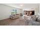 Spacious living room featuring modern sofas, a glass coffee table, and an open floor plan at 3512 Gibbon Terrace Ct, Charlotte, NC 28269