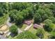 Aerial view of a secluded home surrounded by lush greenery and mature trees at 393 Carson Dr, Gastonia, NC 28052