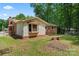 Exterior view of a home, showcasing the brick siding and a spacious backyard with mature trees at 393 Carson Dr, Gastonia, NC 28052