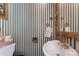 Bathroom features striped wallpaper, gold accents, and unique sink at 393 Carson Dr, Gastonia, NC 28052