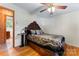 Bedroom featuring hardwood floors, a ceiling fan, and furniture, creating a cozy and inviting space at 393 Carson Dr, Gastonia, NC 28052