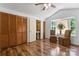 Bedroom features a bay window, ceiling fan, and wood-look floors at 393 Carson Dr, Gastonia, NC 28052