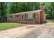 Classic brick home with a spacious front yard, featuring a brick chimney and mature trees at 393 Carson Dr, Gastonia, NC 28052