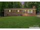 Charming brick home featuring a well-manicured lawn and mature trees, offering great curb appeal at 393 Carson Dr, Gastonia, NC 28052