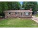 Inviting brick home with a well-kept lawn, classic shutters, and a welcoming front entrance at 393 Carson Dr, Gastonia, NC 28052