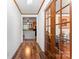 Inviting hallway with warm wood floors, decorative trim, and a view into the kitchen at 393 Carson Dr, Gastonia, NC 28052