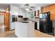 Functional kitchen with white cabinets, a central island, and a ceiling fan for comfort at 393 Carson Dr, Gastonia, NC 28052