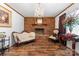 Cozy living room with a brick fireplace, wood floors, and elegant furnishings at 393 Carson Dr, Gastonia, NC 28052