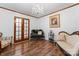 Elegant living room featuring detailed woodwork, stylish furniture, and a classic chandelier at 393 Carson Dr, Gastonia, NC 28052