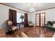 Sophisticated living room showcasing dark wood floors, an elegant chandelier, and detailed window treatments at 393 Carson Dr, Gastonia, NC 28052