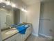 Bright bathroom features double vanity with a shower and tile surround at 412 Nathaniel Way # Brx0052, Charlotte, NC 28213
