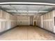 Unfinished two car garage with high ceilings and concrete floors at 412 Nathaniel Way # Brx0052, Charlotte, NC 28213
