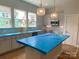 Modern kitchen design with gray cabinets, island, and stainless steel microwave, all bathed in natural light at 412 Nathaniel Way # Brx0052, Charlotte, NC 28213