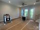 Bright living room with new appliances, ceiling fan, and a door leading to an outdoor balcony at 412 Nathaniel Way # Brx0052, Charlotte, NC 28213