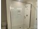 New tiled shower features glass doors and a tiled shower niche at 412 Nathaniel Way # Brx0052, Charlotte, NC 28213