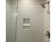 Close-up of the tiled shower with niche and brushed nickel showerhead and faucet at 412 Nathaniel Way # Brx0052, Charlotte, NC 28213