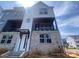 Modern townhome with brick and siding, featuring a welcoming entrance and a balcony, perfect for outdoor living at 416 Nathaniel Way # Brx0051, Charlotte, NC 28213