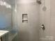 This is a close up of the shower featuring a shelf and brushed nickel hardware at 416 Nathaniel Way # Brx0051, Charlotte, NC 28213
