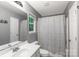 Bright bathroom featuring a white vanity, tub/shower combination with tiled walls, and a window at 4332 Bathurst Dr, Charlotte, NC 28227