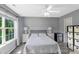 Comfortable bedroom featuring a ceiling fan, bedside tables, and ample natural light at 4332 Bathurst Dr, Charlotte, NC 28227