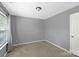A simple bedroom with neutral walls, carpeted floors, a window, and a closet at 4332 Bathurst Dr, Charlotte, NC 28227