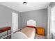 Cozy bedroom with a twin bed, gray walls, and natural light from a window at 4332 Bathurst Dr, Charlotte, NC 28227