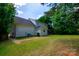 Back exterior view of the two story house with a well maintained lawn, shed, and partial fence at 4332 Bathurst Dr, Charlotte, NC 28227