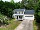 Charming two-story home featuring a manicured front yard, covered porch, and attached two-car garage at 4332 Bathurst Dr, Charlotte, NC 28227