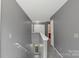 Upstairs hallway with neutral paint, carpeted stairs, and easy access to all bedrooms and bathrooms at 4332 Bathurst Dr, Charlotte, NC 28227
