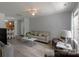 A bright living room featuring hardwood floors, neutral walls, and an open-concept layout at 4332 Bathurst Dr, Charlotte, NC 28227
