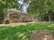 Expansive backyard featuring brick house, patio, and mature landscaping at 4701 Pineland Pl, Charlotte, NC 28277