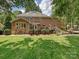 Brick house features a deck and stairs leading to a spacious, well-maintained backyard at 4701 Pineland Pl, Charlotte, NC 28277