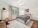 Comfortable bedroom with ceiling fan, large window, and neutral decor at 4701 Pineland Pl, Charlotte, NC 28277