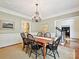 Elegant dining room with chandelier, molding, and views to other rooms at 4701 Pineland Pl, Charlotte, NC 28277