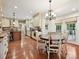 Inviting dining room with hardwood floors, chandelier, and a view of the adjacent modern kitchen at 4701 Pineland Pl, Charlotte, NC 28277