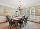 Formal dining room with chandelier, multiple windows, and elegant decor at 4701 Pineland Pl, Charlotte, NC 28277