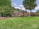 Traditional brick home with manicured lawn and mature trees providing curb appeal at 4701 Pineland Pl, Charlotte, NC 28277
