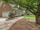 Brick home features a walkway, well manicured landscaping, and three-car garage at 4701 Pineland Pl, Charlotte, NC 28277