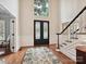 Bright foyer with double doors, hardwood floors, wainscoting, and elegant staircase at 4701 Pineland Pl, Charlotte, NC 28277