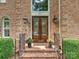 Elegant double front door with glass inserts, flanked by sconces and planters at 4701 Pineland Pl, Charlotte, NC 28277