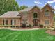 Charming brick home with manicured lawn, mature trees, and inviting entryway at 4701 Pineland Pl, Charlotte, NC 28277