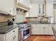 Gourmet kitchen with stainless steel oven, granite countertops, custom backsplash, and ample cabinetry at 4701 Pineland Pl, Charlotte, NC 28277