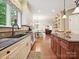 Modern kitchen featuring hardwood floors, granite countertops, stainless appliances, and view to dining area at 4701 Pineland Pl, Charlotte, NC 28277