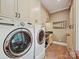 Modern laundry room with large appliances and storage at 4701 Pineland Pl, Charlotte, NC 28277