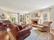 Cozy living room with brick fireplace, built-in shelves, and comfortable seating at 4701 Pineland Pl, Charlotte, NC 28277